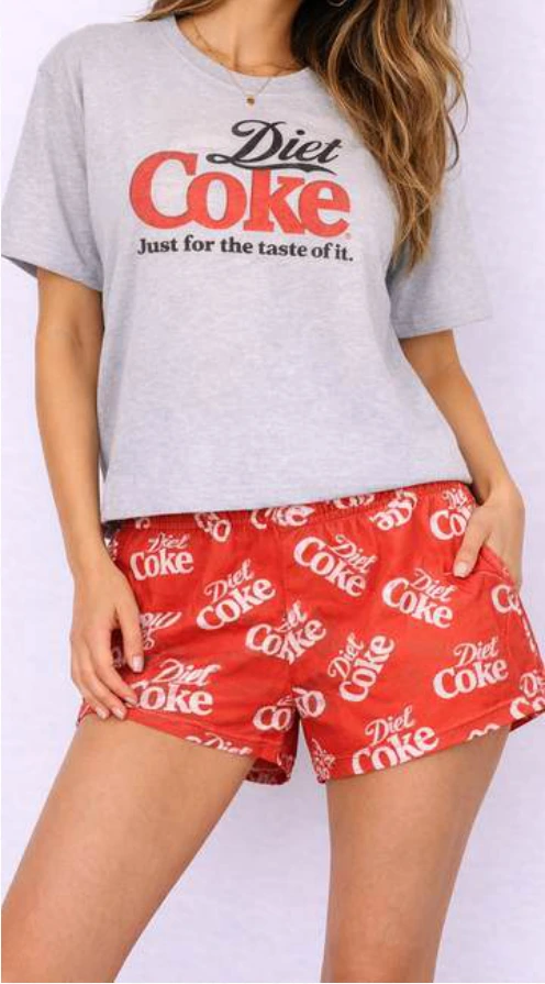 Diet Coke gray tee and red printed shorts.